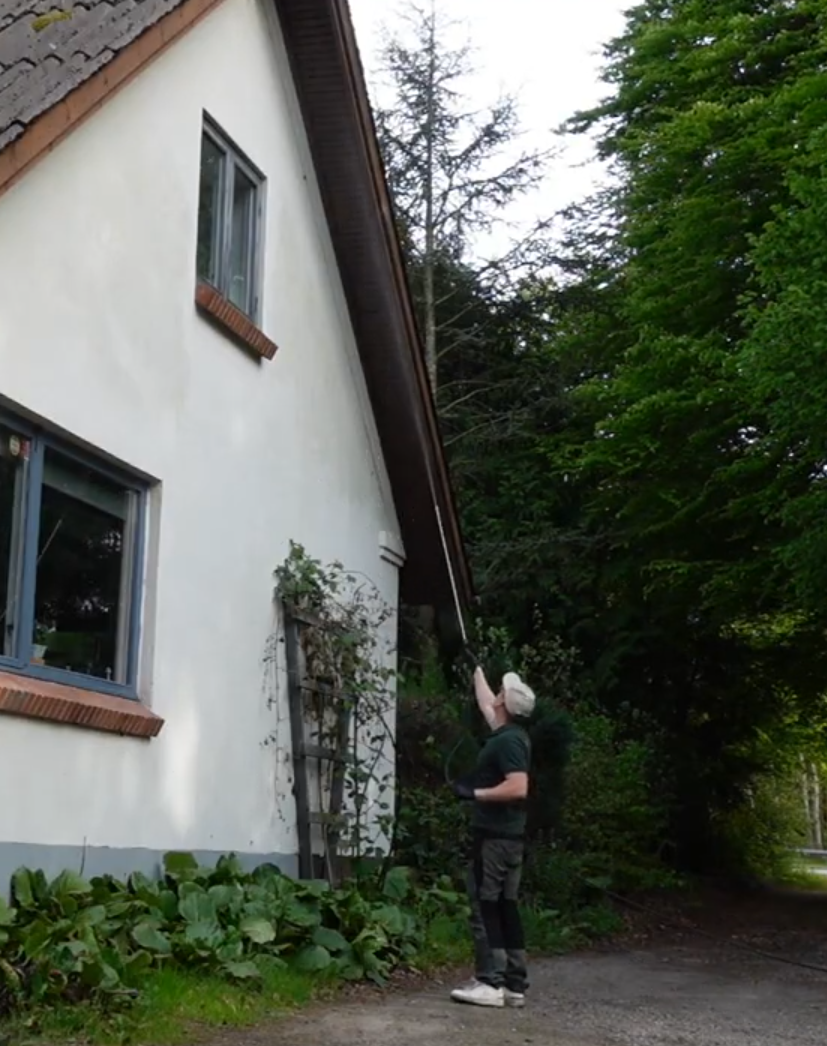 Skadedyrstekniker sprøjter mod edderkopper ved udhæng